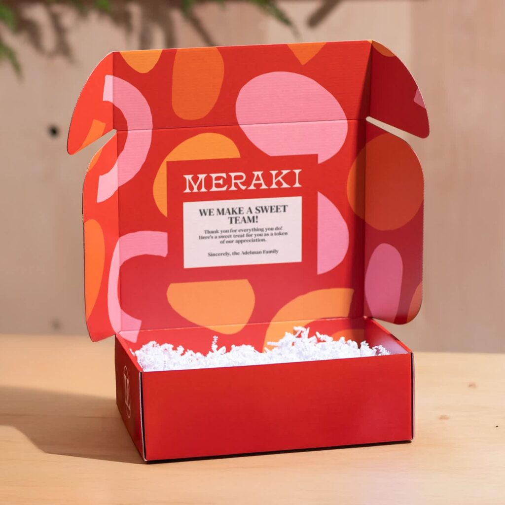 Open red mailer box with a welcome message.