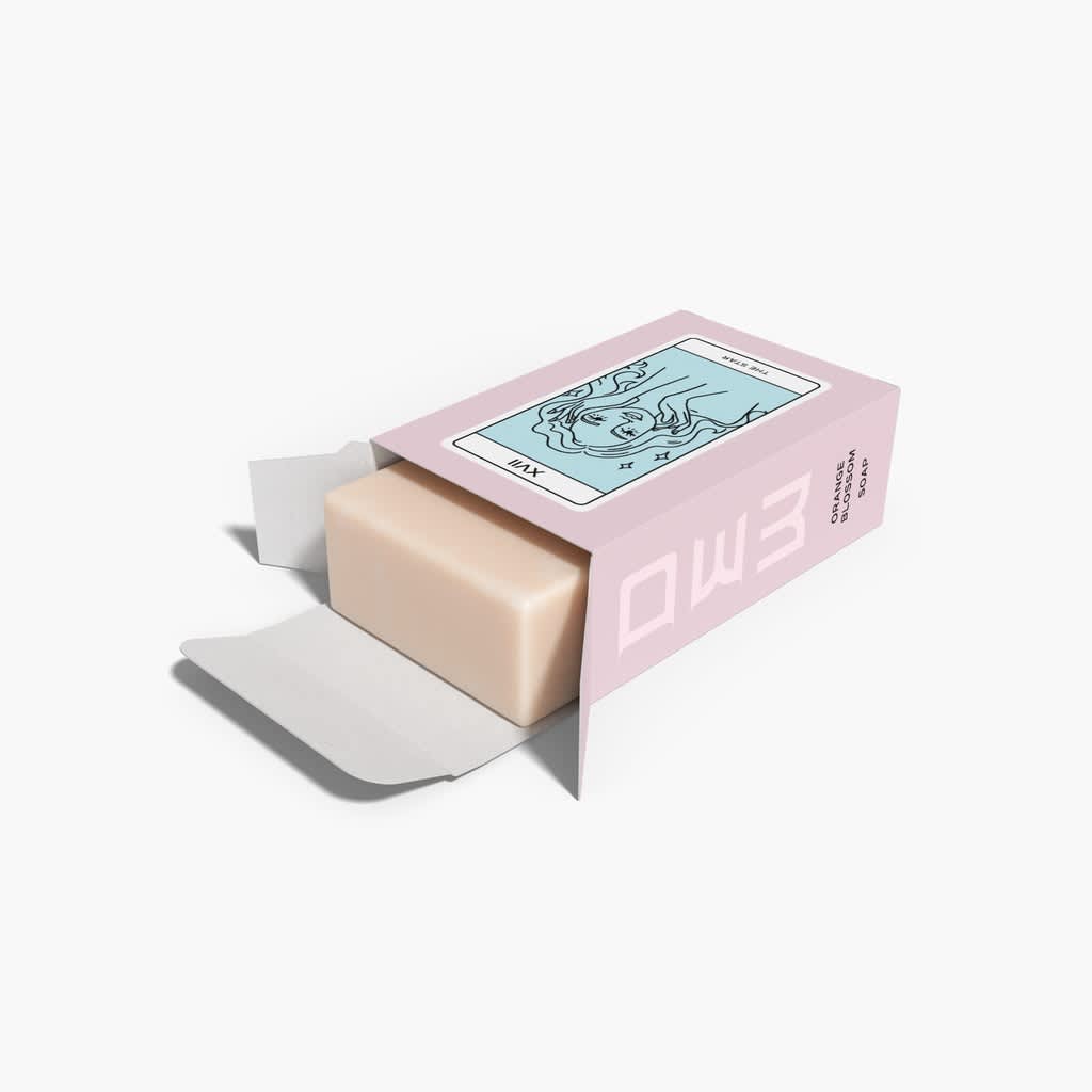 A pink and blue cardboard box package decorated with an illustration of a woman’s face, containing soap.