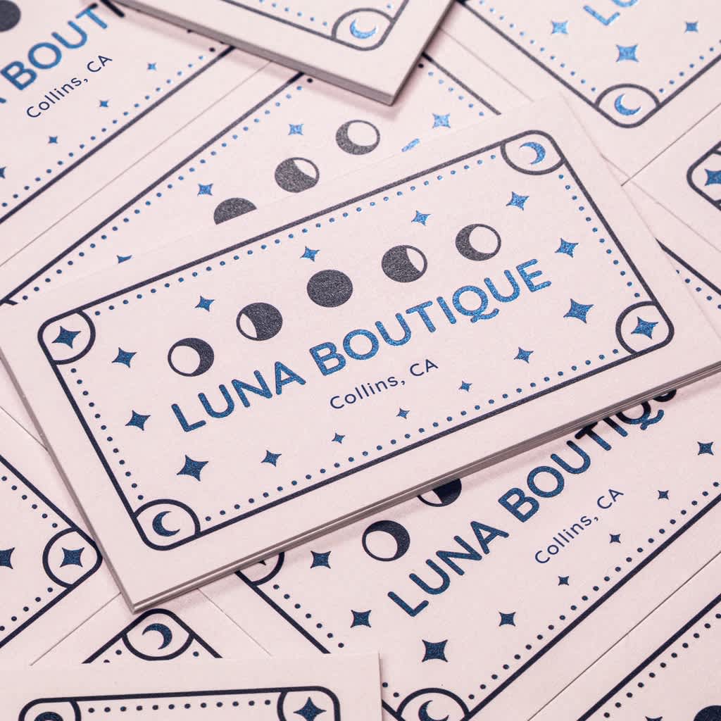 Business cards decorated with moons and stars and branded with a clear sans-serif logo.