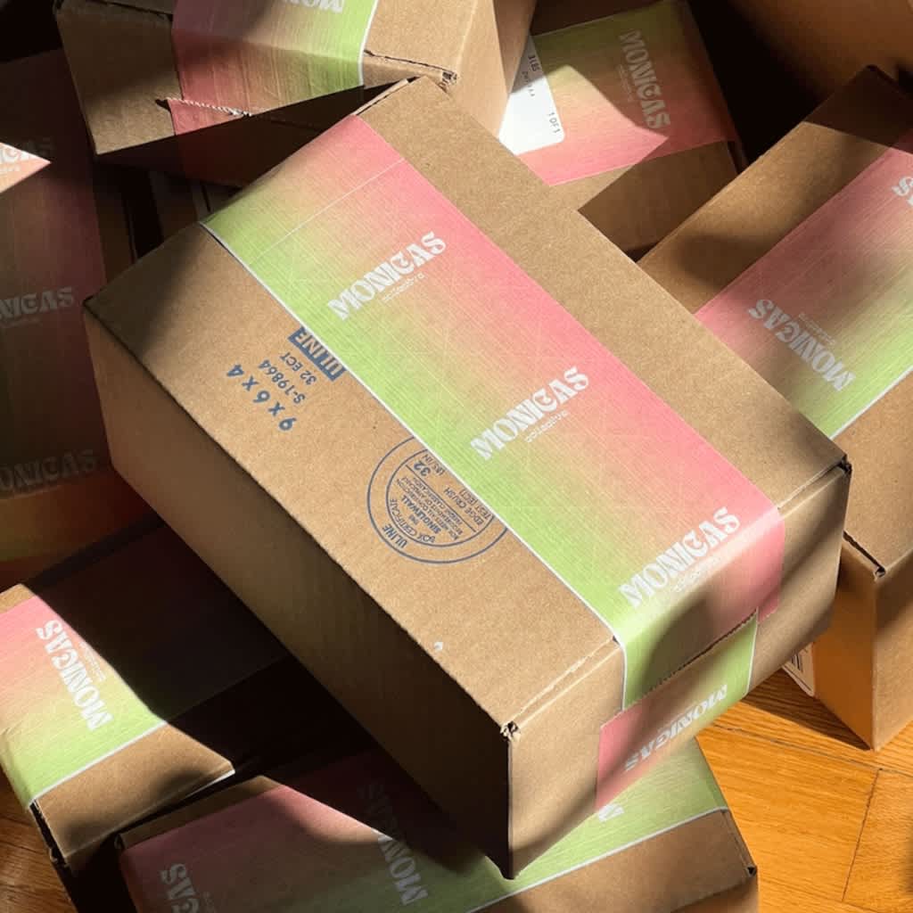 Eco-friendly cardboard box packaging with branded tape.