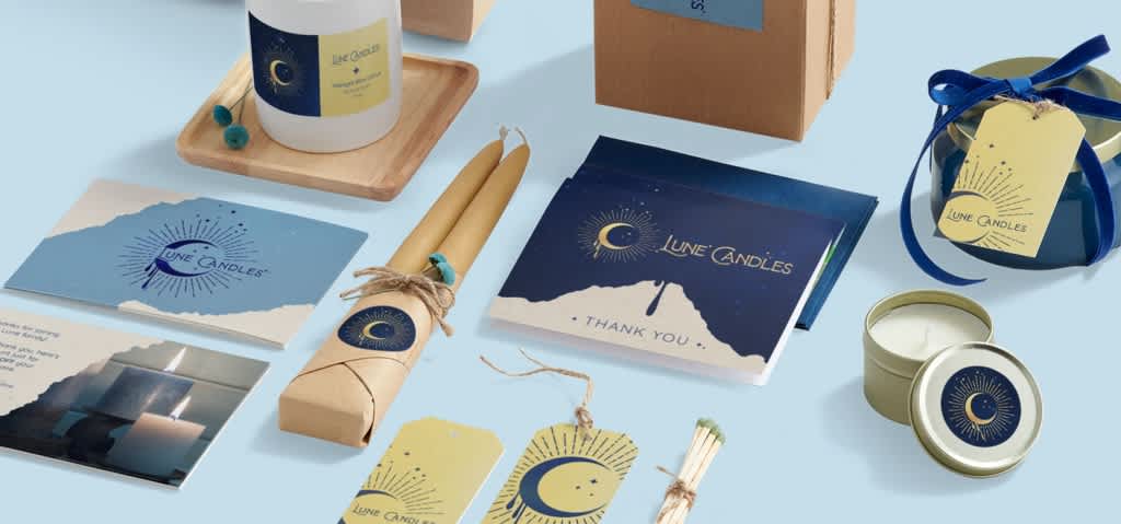 A collection of eco-friendly cardboard packaging, boxes, tags and thank-you notes for a candle brand.