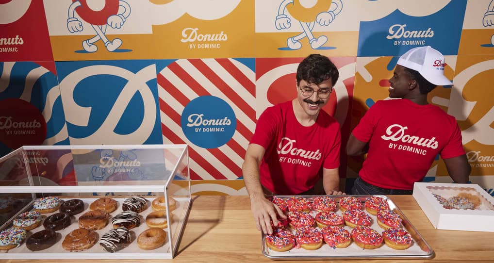 small business colleagues working at a donut stand