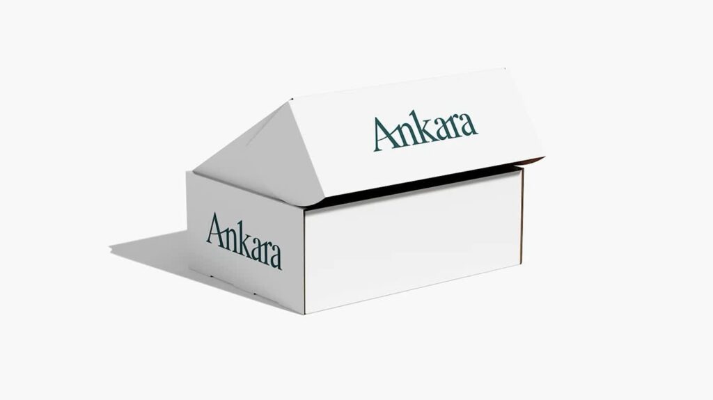 Minimalist packaging design featuring a clean white folding box with a single serif wordmark printed in muted green.