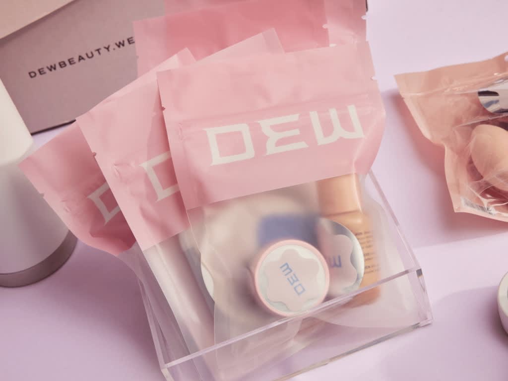 Pink and clear pouch packaging for a beauty brand.