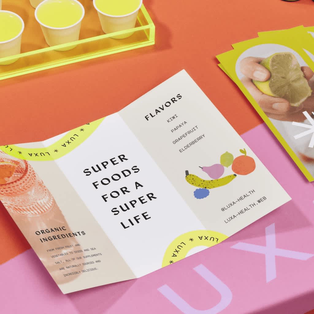 Tri-fold flyer open on a table advertising flavors for their product with graphics of fruit.