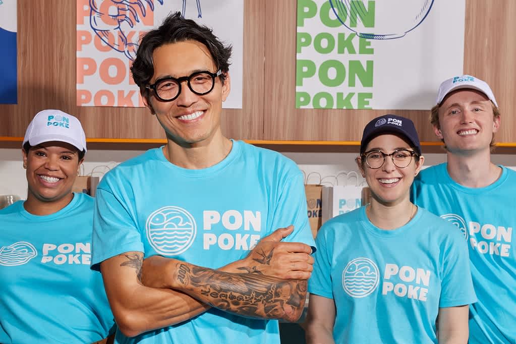 Small business employees wearing blue branded T-shirts for a cohesive team look.