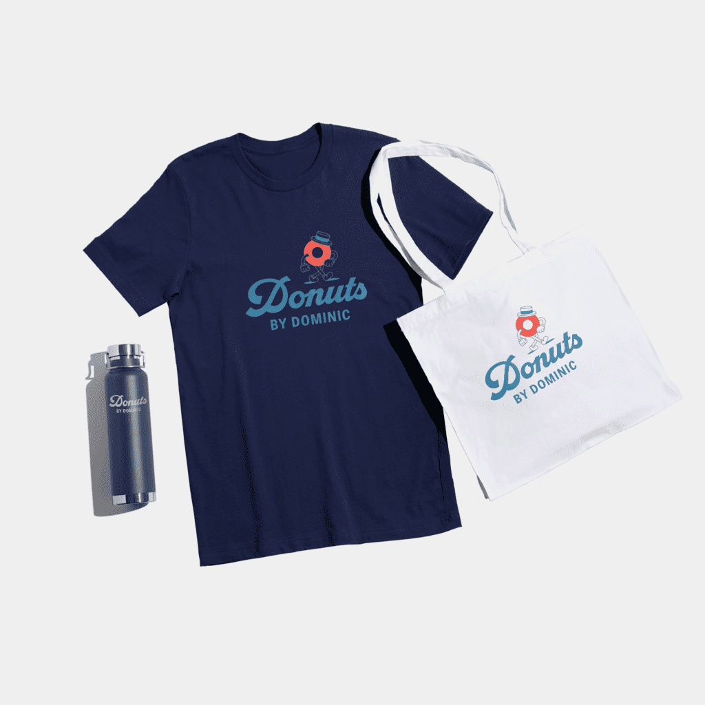 Dark blue T-shirt with light blue font &ldquo;Donuts by Dominic.&rdquo;