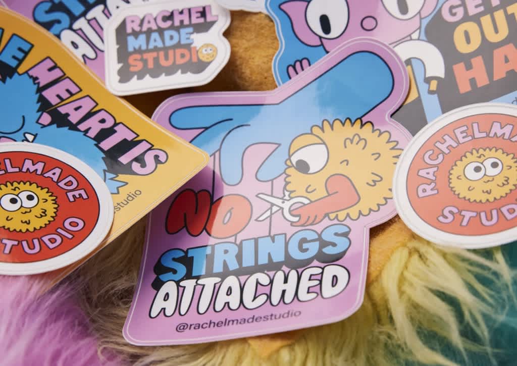 Branded stickers with the brand mascot and message &ldquo;No strings attached&rdquo; used as packaging inserts.