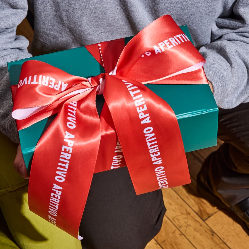 A festive box packaged in red and green decorative wrapping.