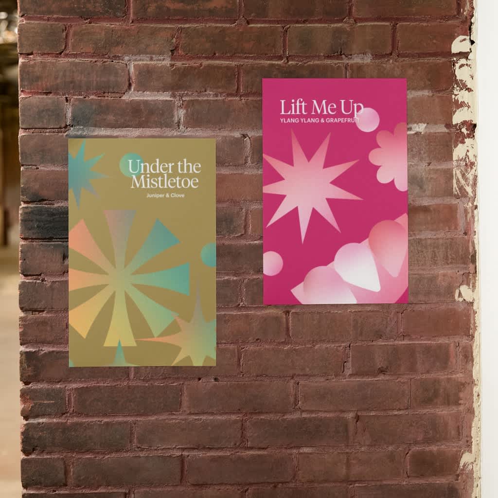 Festive posters with Christmas bauble graphics attached to brick wall.