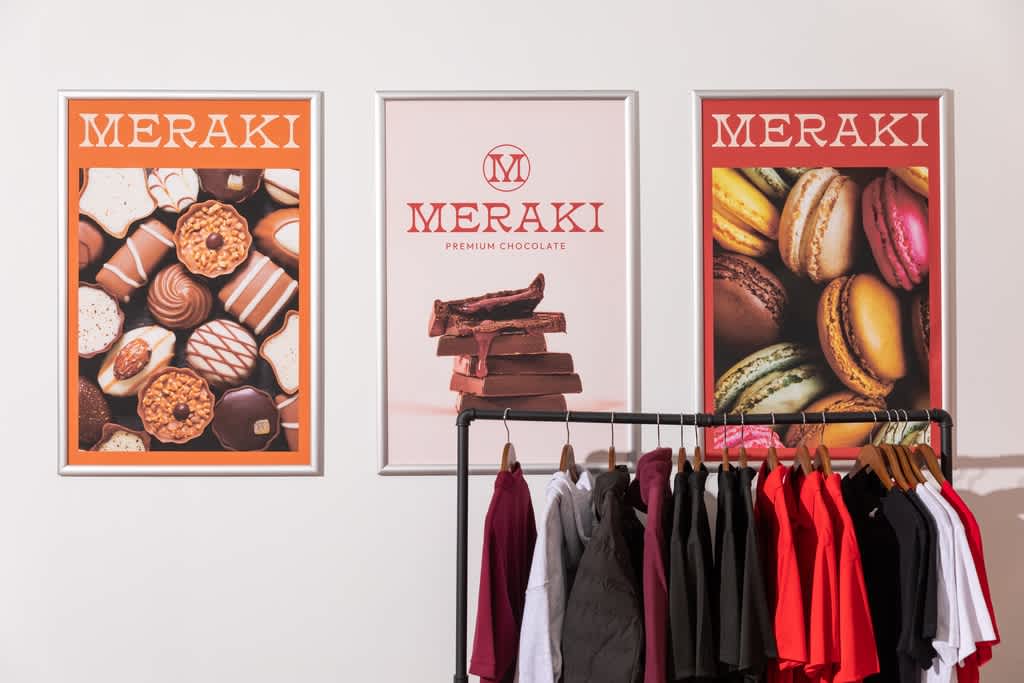 Holiday posters in store with product photos of confectionery.