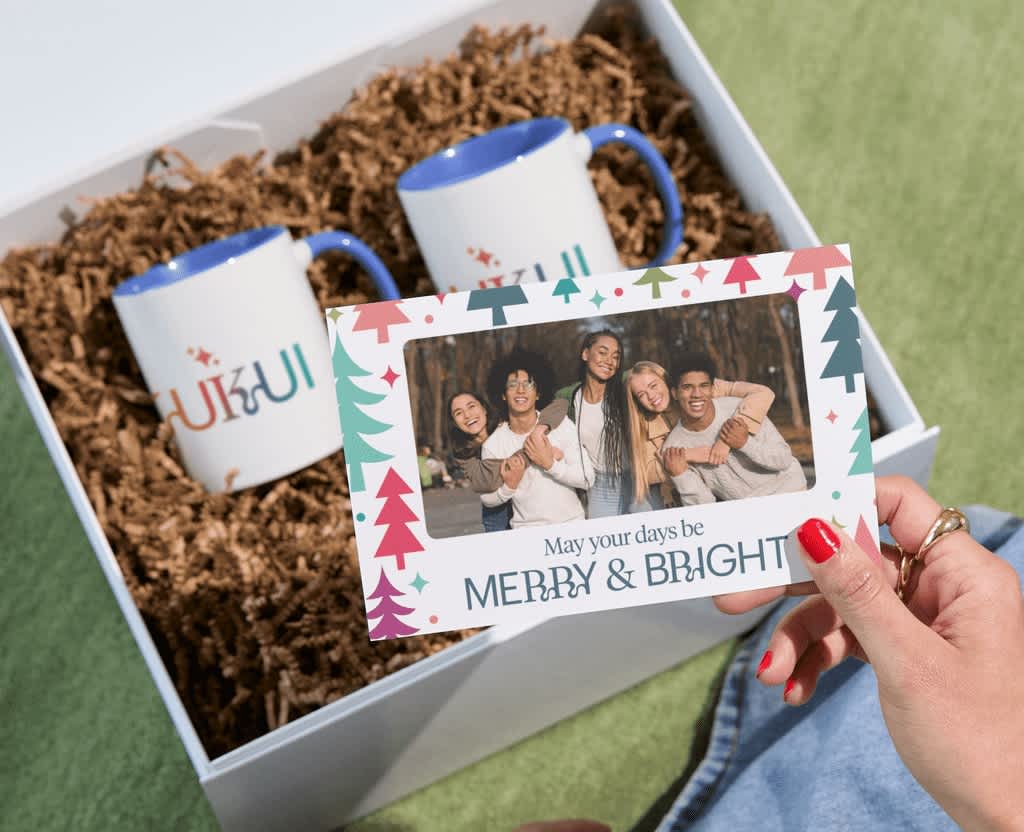 Branded mugs and a personal card as example of holiday giveaway with store purchase.