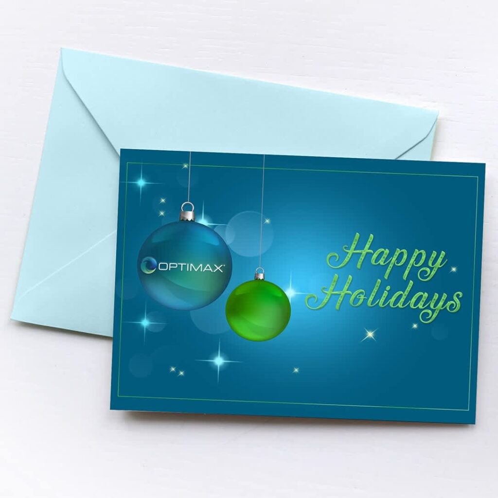 Landscape Christmas card with hanging ornament illustrations displayed in a matching envelope.