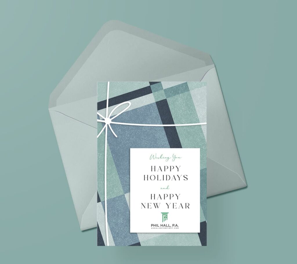 Portrait Christmas card with a geometric gift-wrap design displayed in a matching envelope.