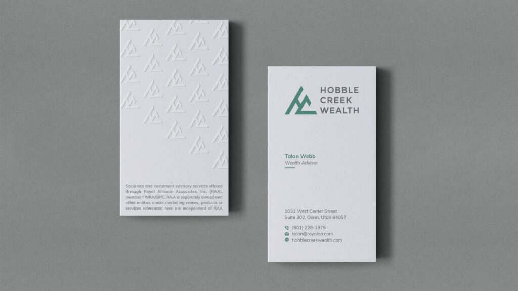 Crisp white business cards with green and gray accents, using subtle embossing to add depth to a minimalist design.