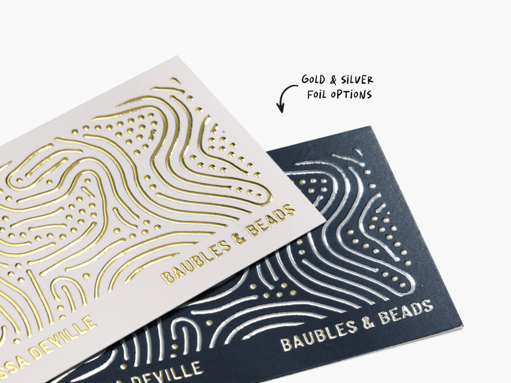 Two business cards with gold and silver raised gold foil finishes.