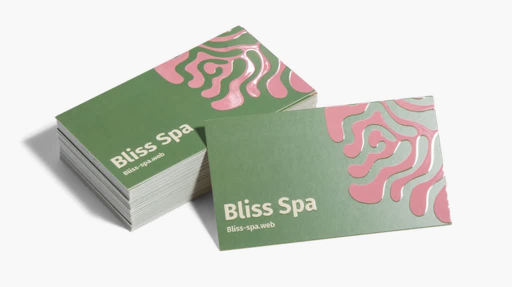 Green business cards with pink accents, showing how contrasting colors can create a distinctive, balanced palette.