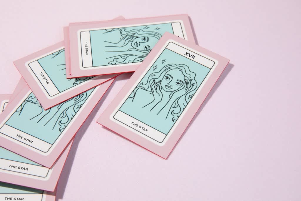 Pastel pink and powder blue business cards with black line illustrations and white details, combining soft, low-saturation colors in a playful palette that reflects the 2027 pastel trend.