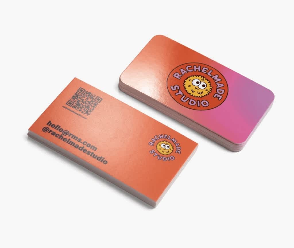 A red and pink business card with a QR code and social handle on the reverse.