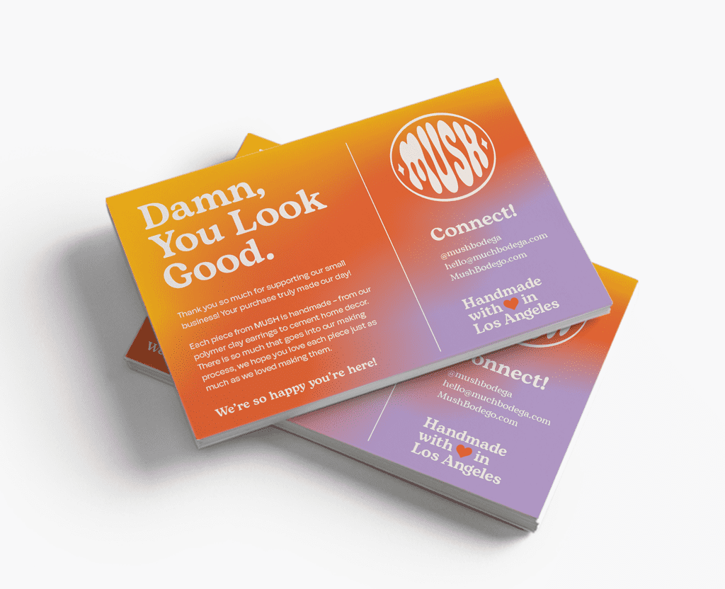 Colorful business cards with the brand’s contact details and social media handle.