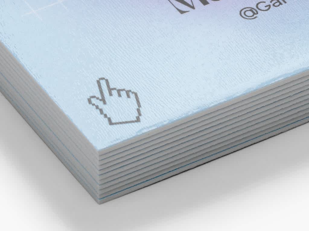 Stack of business cards with a cursor icon and textured paper finish.