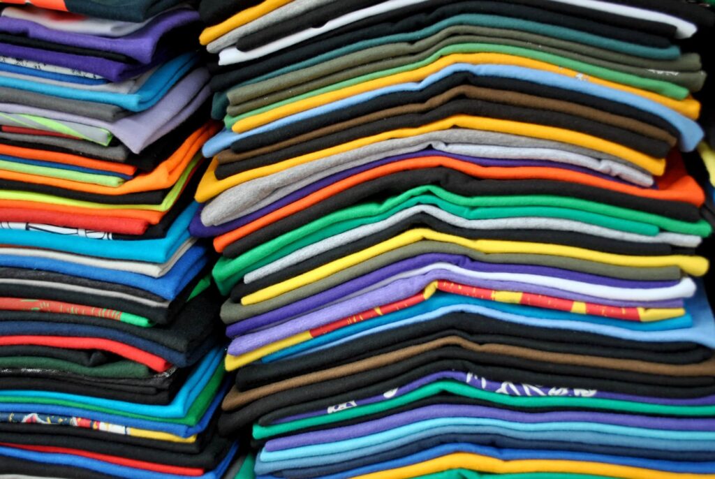 Stacks of folded t-shirts.