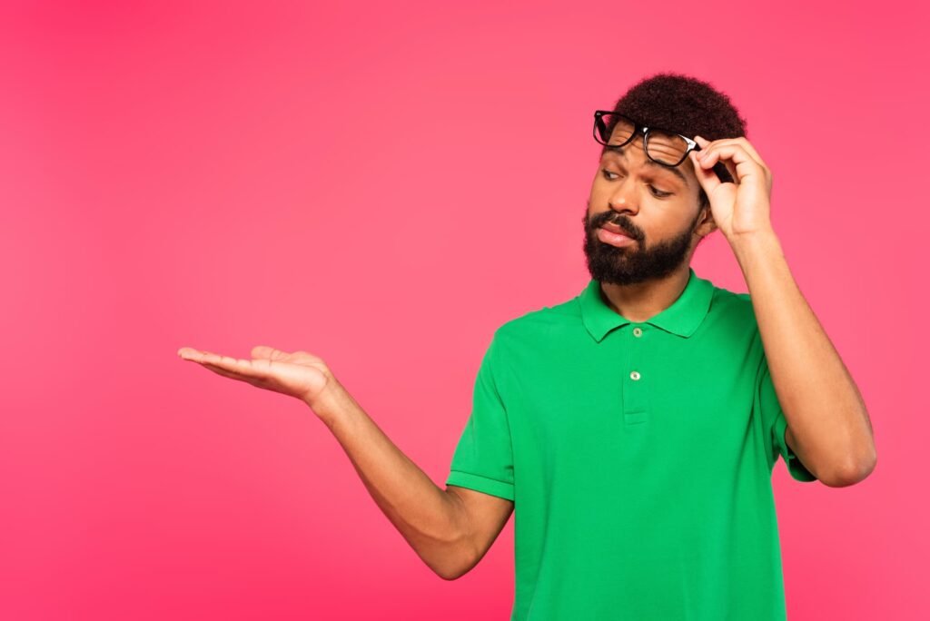 Person wearing a bright green polo shirt against a pink background.