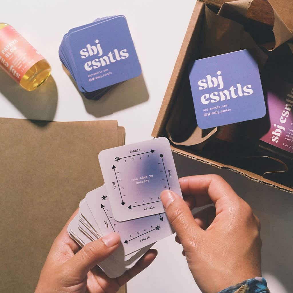 Purple square business cards with a clear logo and creative design.
