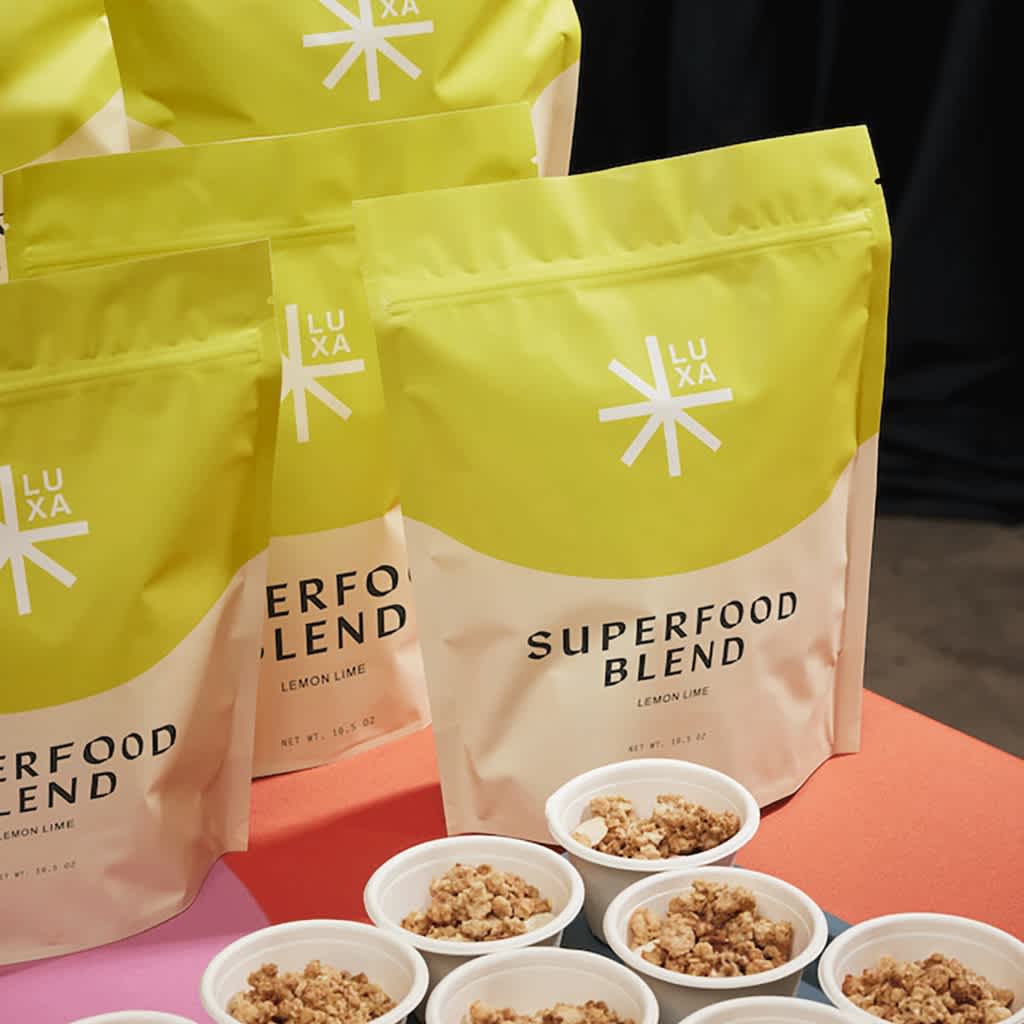 Light green branded pouches with Luxa brand logo and Superfood Blend product name.