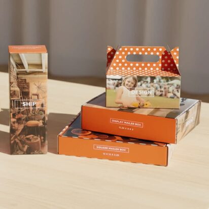Assorted colorful printed packaging boxes displayed on a wooden table.