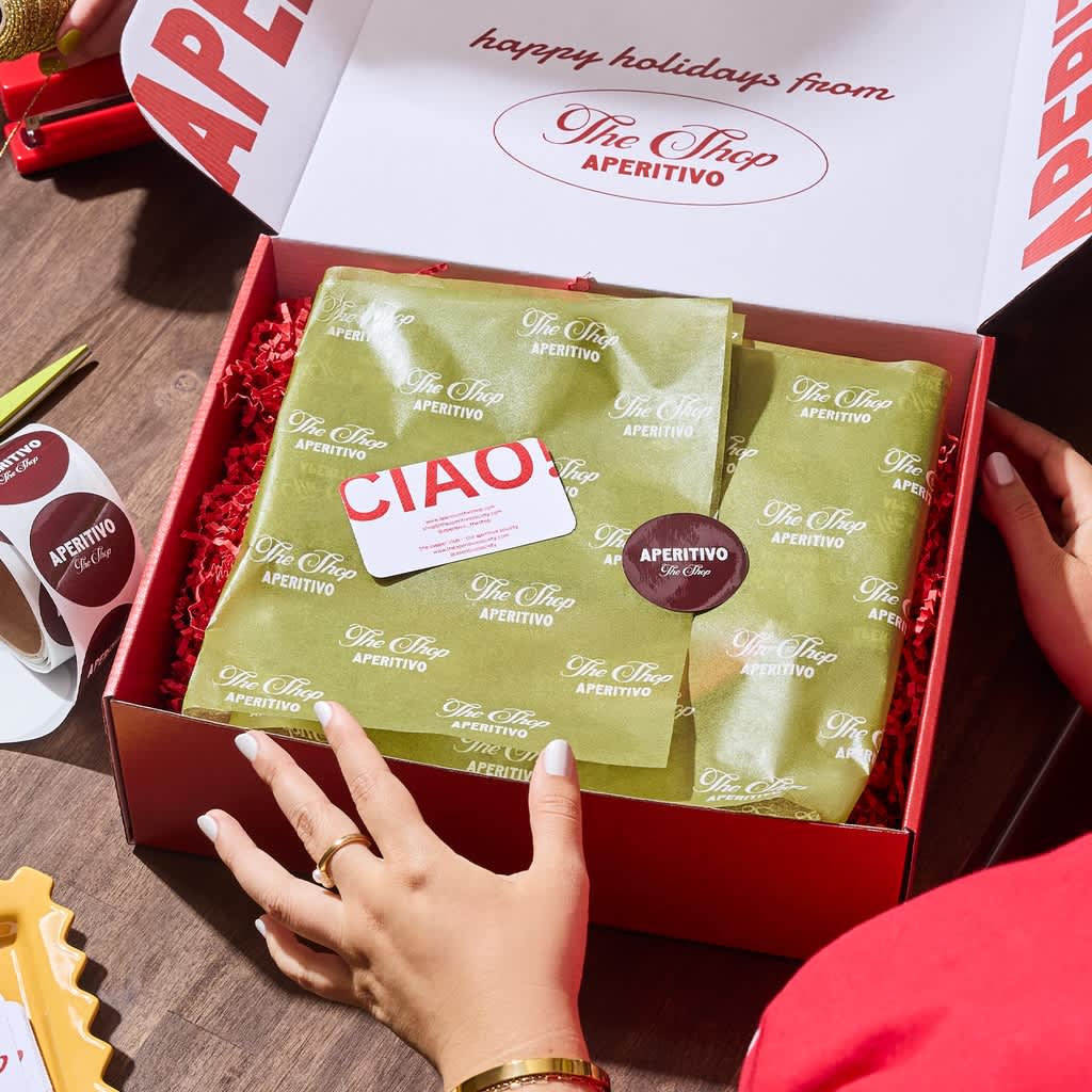 A festive box packed with green tissue paper.