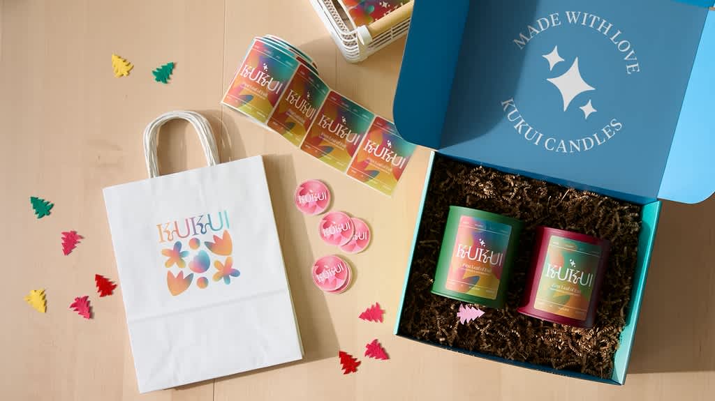 Holiday packaging with custom branded tape, stickers and paper bags.