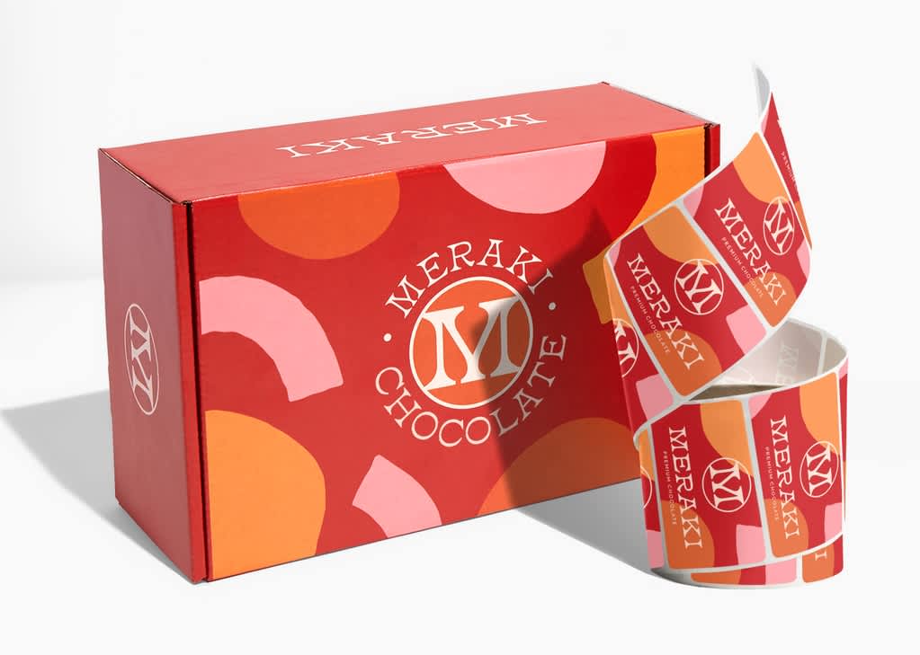Product packaging: Red branded mailer box with logo, brand name and custom stickers.