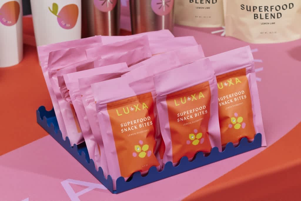 Pink and orange superfood snack bite pouches retail packaging design trade show display.