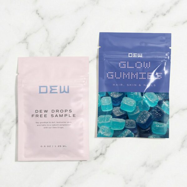 Two DEW Beauty sample pouches, including pink DEW Drops skincare packaging and a blue GLOW GUMMIES pouch, displayed on a white marble surface.