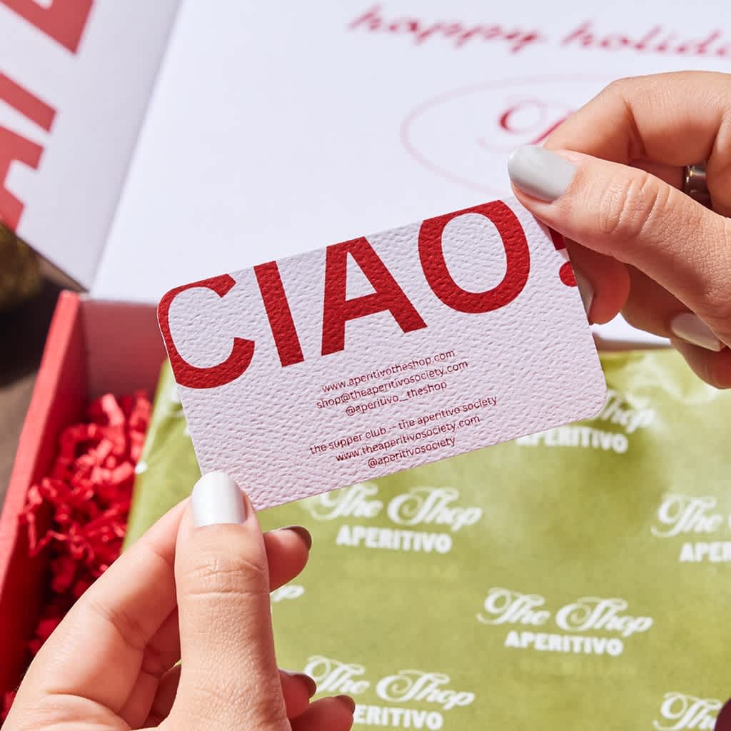 Textured white business card with red text for the Aperitivo society.