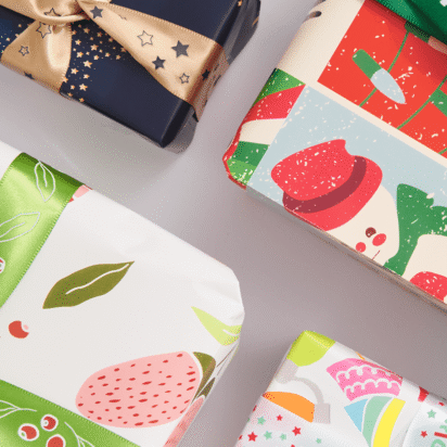 Christmas gifts wrapped in bright patterned paper and ribbon