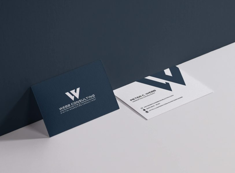 Dark blue business card with white text and large letterform logo