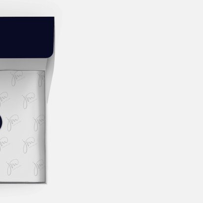 open cardboard gift box with paper neatly folded and sealed with a sticker