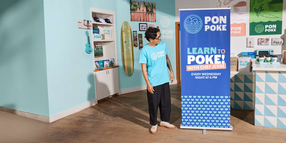 person looks at retractable banner stand in blue to his left