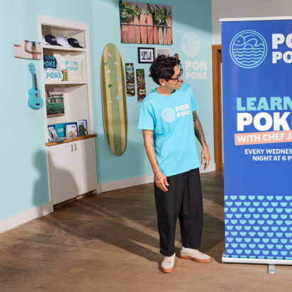 person looks at retractable banner stand in blue to his left