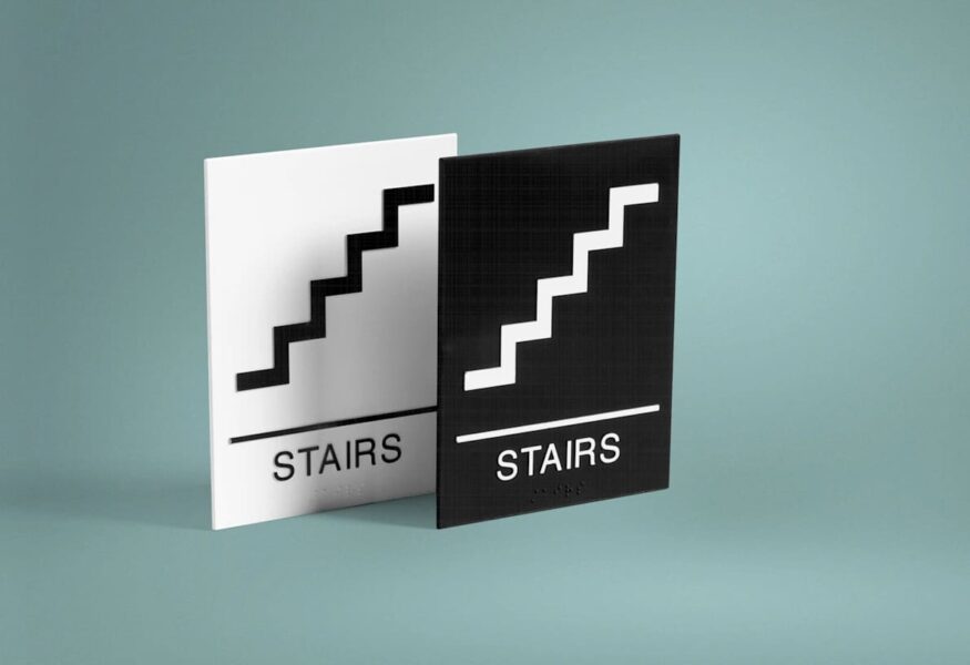 Wayfinding signs to indicate stairs.