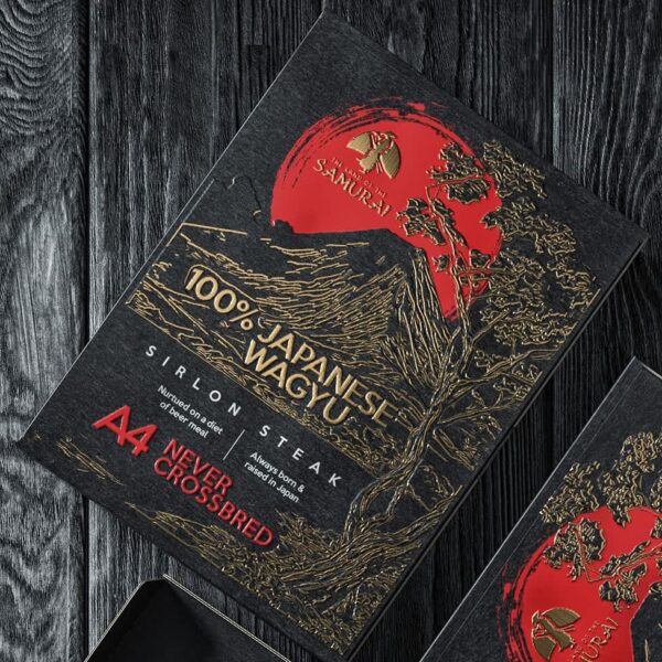 Premium Japanese Wagyu steak packaging with black and gold etched illustrations, bold red accents and ornate detailing&mdash;an example of the Heritage Etch packaging trend 2026