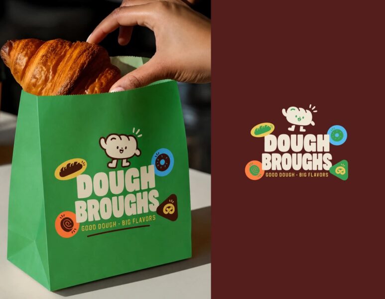 Hand placing a croissant into a green branded bakery paper bag with Dough Broughs logo and colorful illustrations.