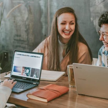 Women with laptops,laughing