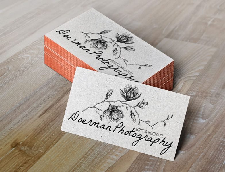 White business card with black text and floral image