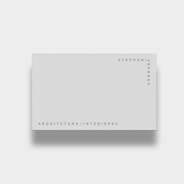 White business card with gray text along the edges