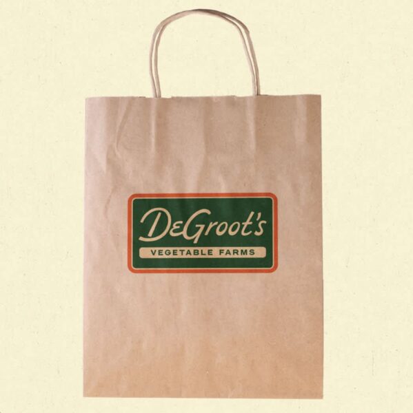 Vintage-inspired logo on paper bag packaging for grocery shop&mdash;an example of the Alt-History packaging trend 2026