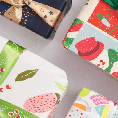 Christmas gifts wrapped in bright patterned paper and ribbon
